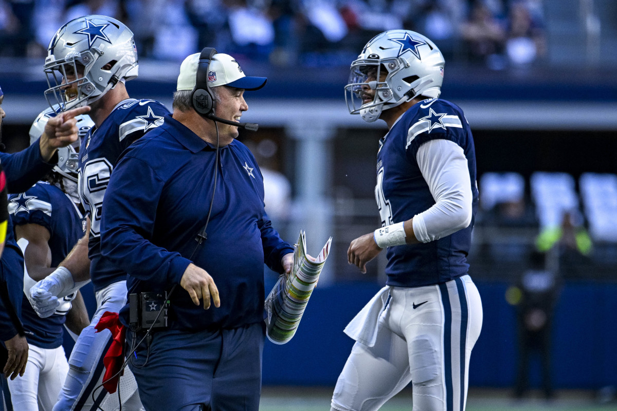 Dallas Cowboys coach Mike McCarthy smiles as quarterback Dak Prescott heads to the sideline.